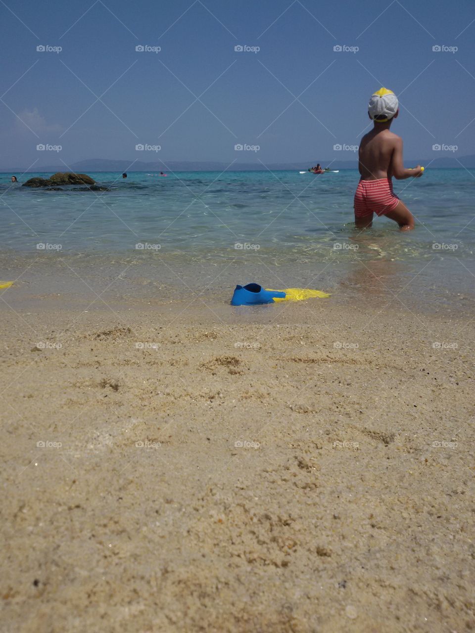 Small boy on the sand beach