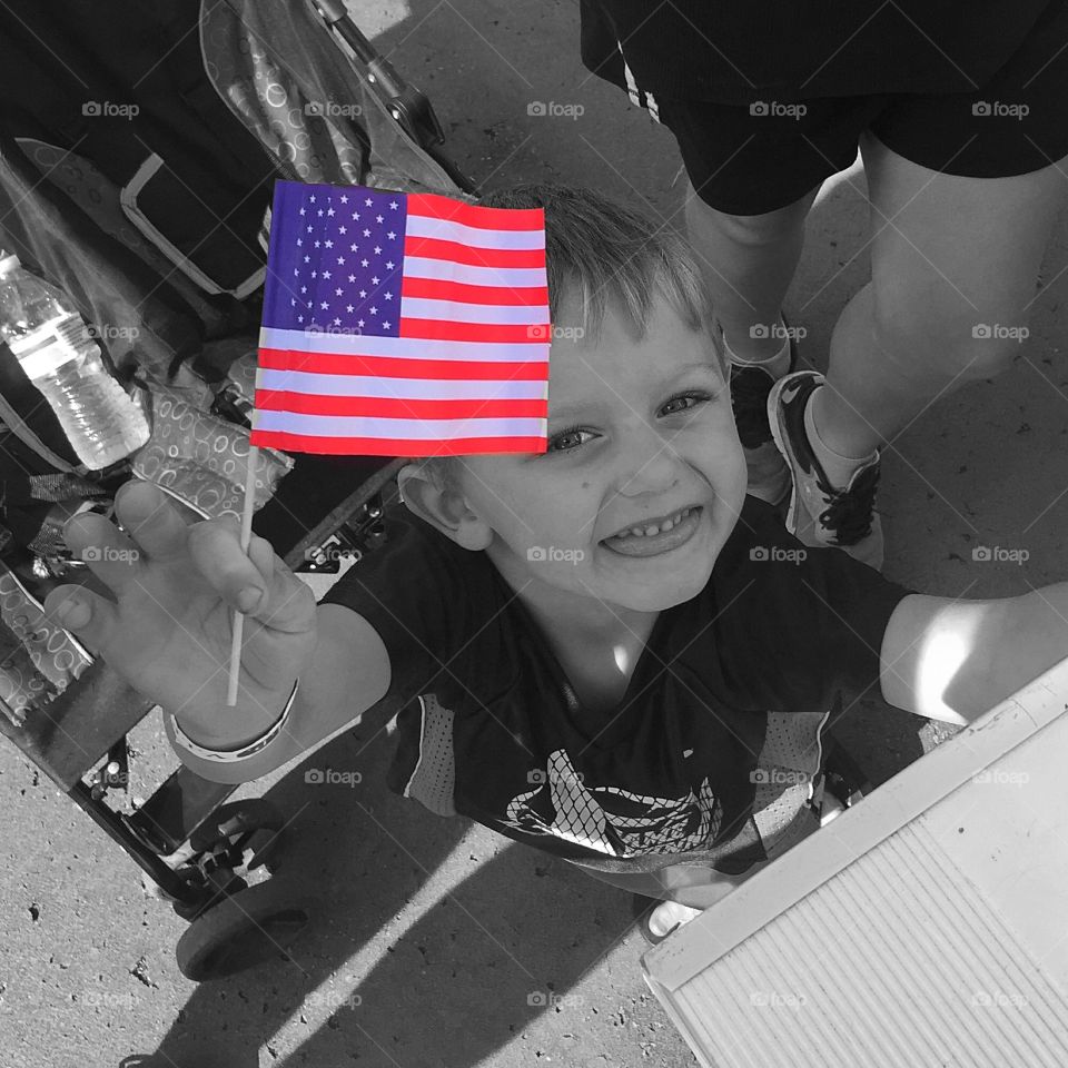 Cute littler boy holding American flag