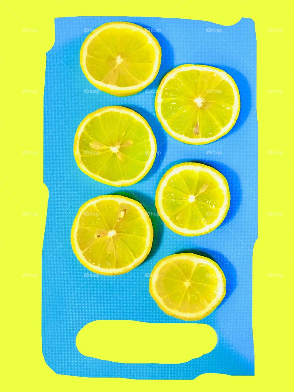 Abstract. Refreshing and sunny lemon slices on blue cutting board