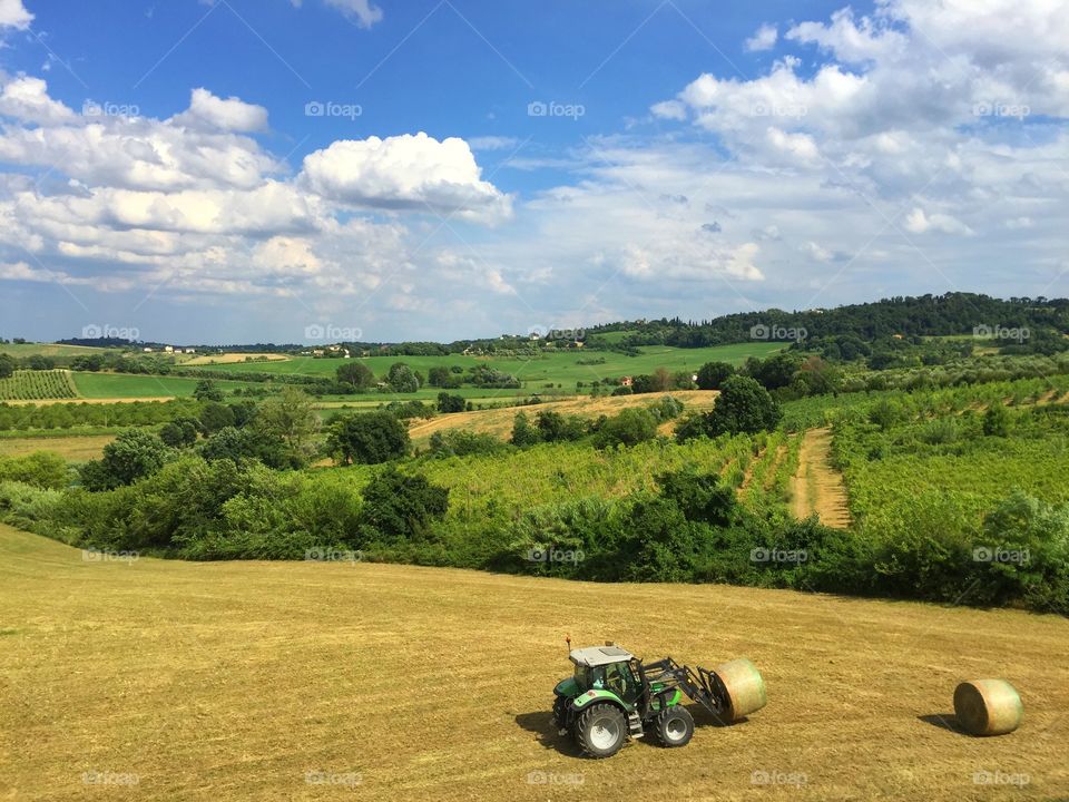 Tractor put the bales in order. Tractor put the bales in order in a green place