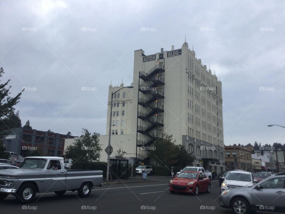 Old Building in Astoria, Oregon with traffic going by