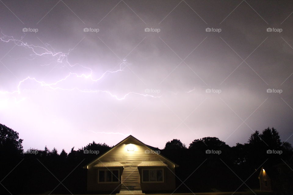 Visible lightning strike above building 