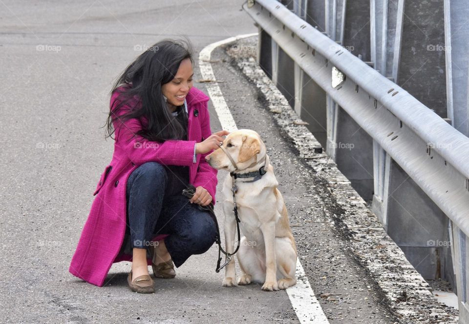 Girl and her dog sharing a special moment while on a walk 