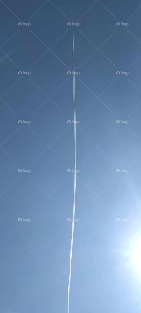 Contrails or vapor trails are line-shaped clouds produced by aircraft engine exhaust or changes in air pressure, typically at aircraft cruising altitudes several miles above the Earth's surface. Contrails are composed primarily of water.