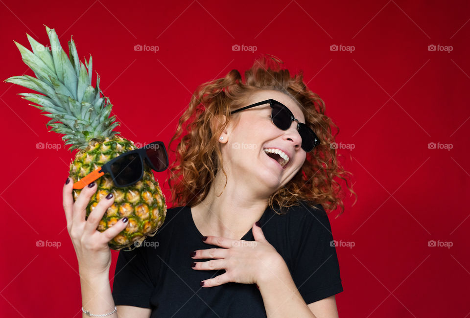 beautiful red-haired girl with pineapple with cool emotions