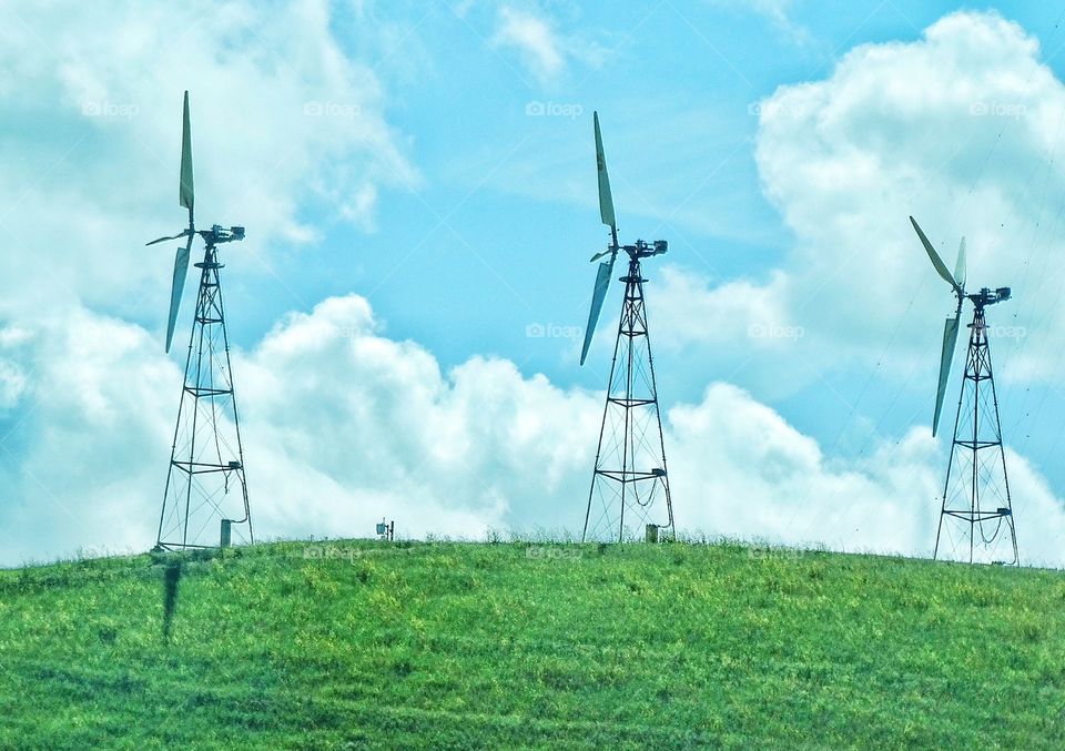 Wind Power Turbines. Power Turbines On A Green Hill Generating Clean Renewable Electricity
