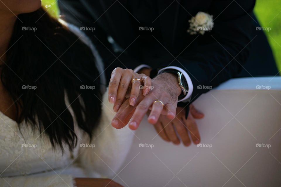 hands of the newlyweds with rings