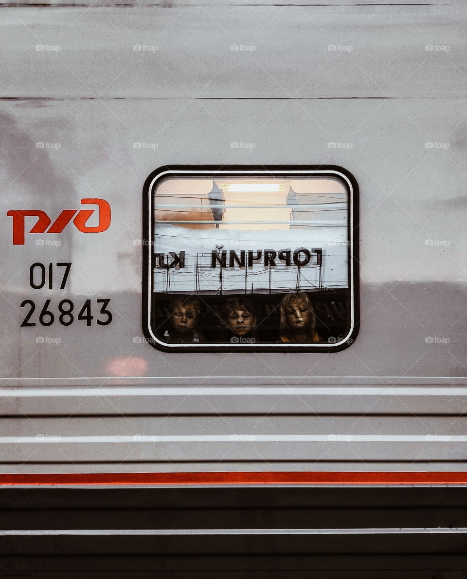 Children look out the train window