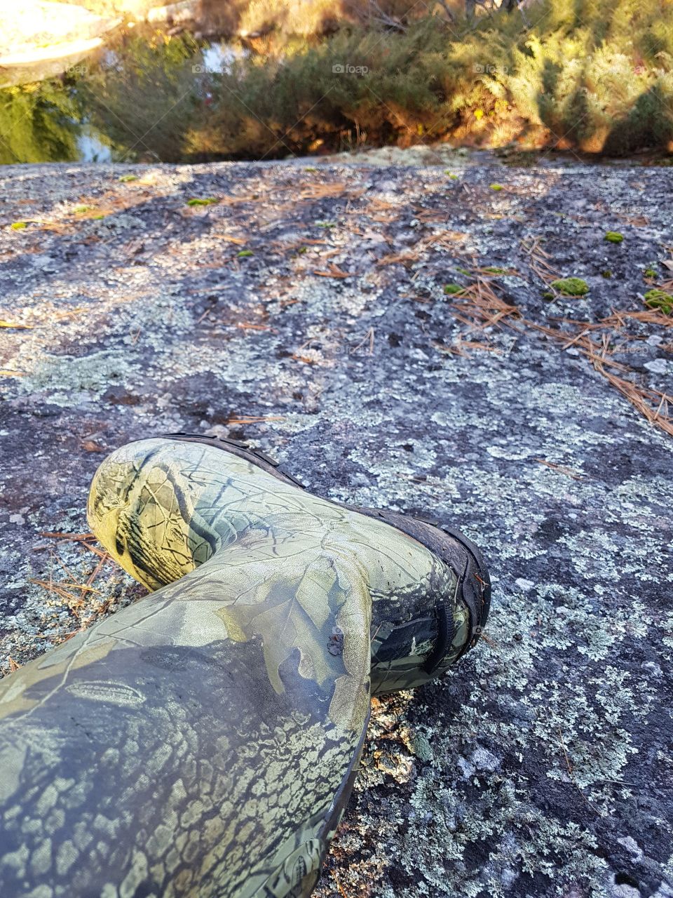 Camo rubber boot on the rock. 