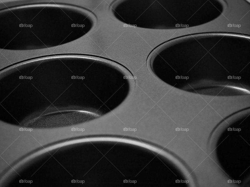A close up shot of a cupcake anti stick pan in dark gray color.