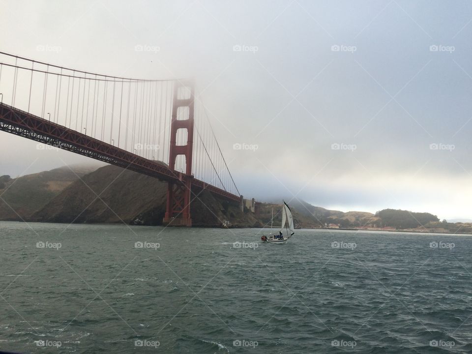 Golden Gate Bridge, late afternoon on a foggy day, seen from San Francisco Bay. 