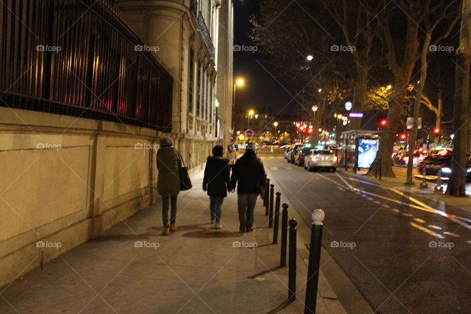 People are Walking in the night during their travel in Paris,France