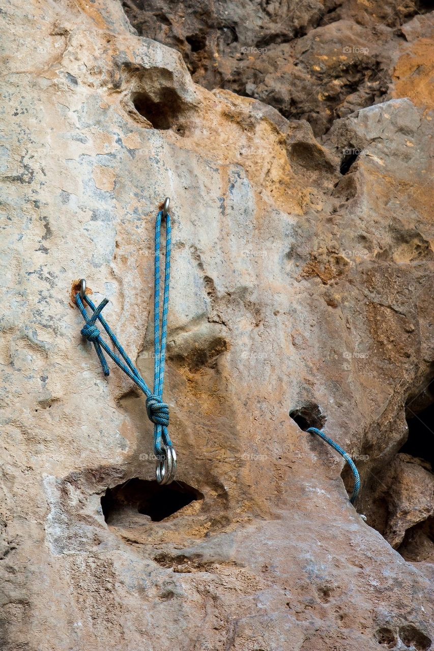 climbing mountain rope pin on cliff