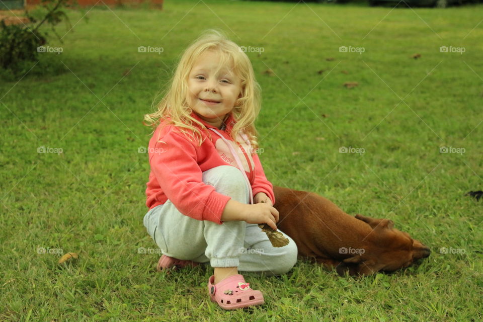 girl with his dog in the grass