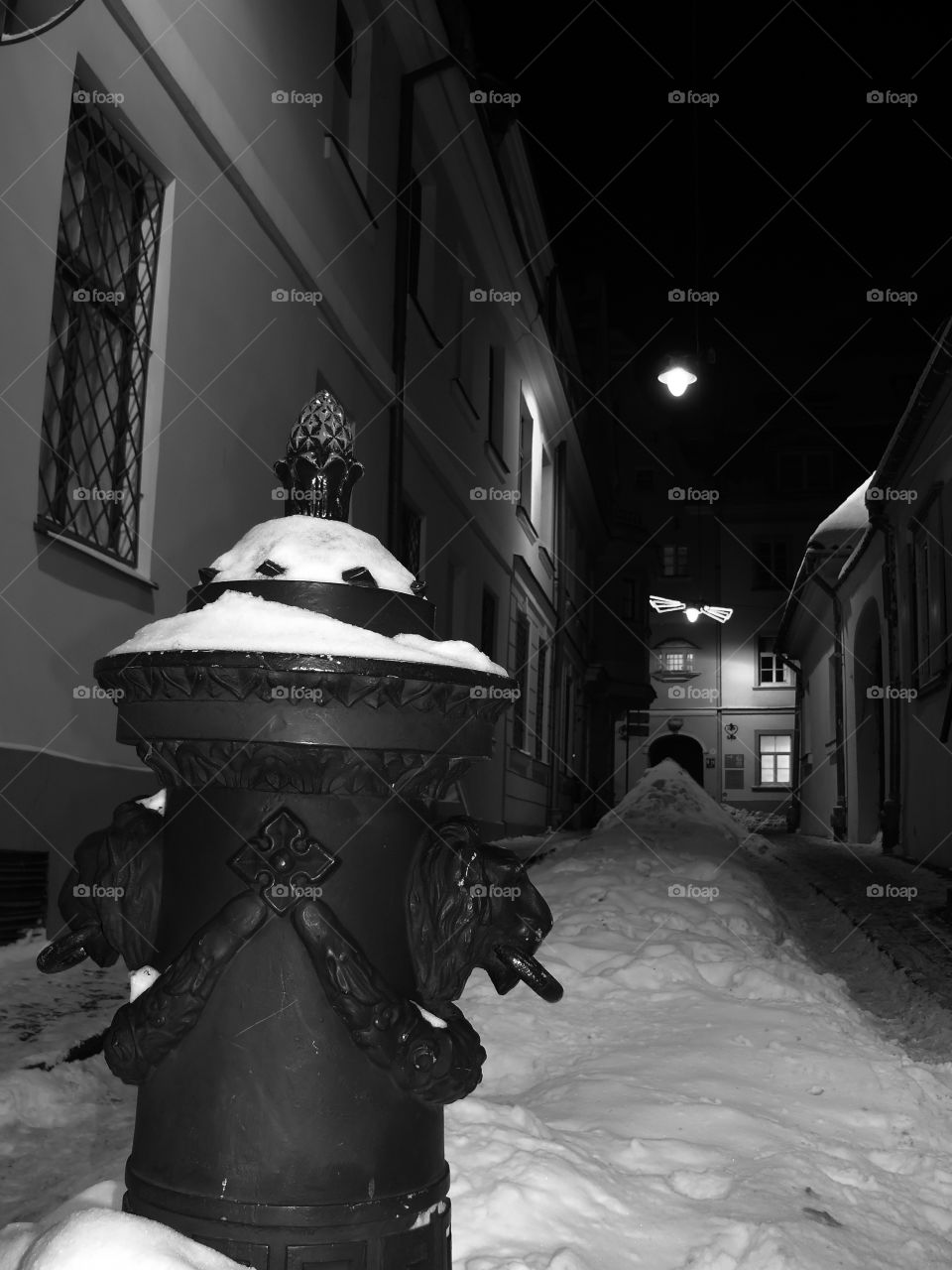 Black and white shot of illuminated architecture by night in Riga, Latvia.