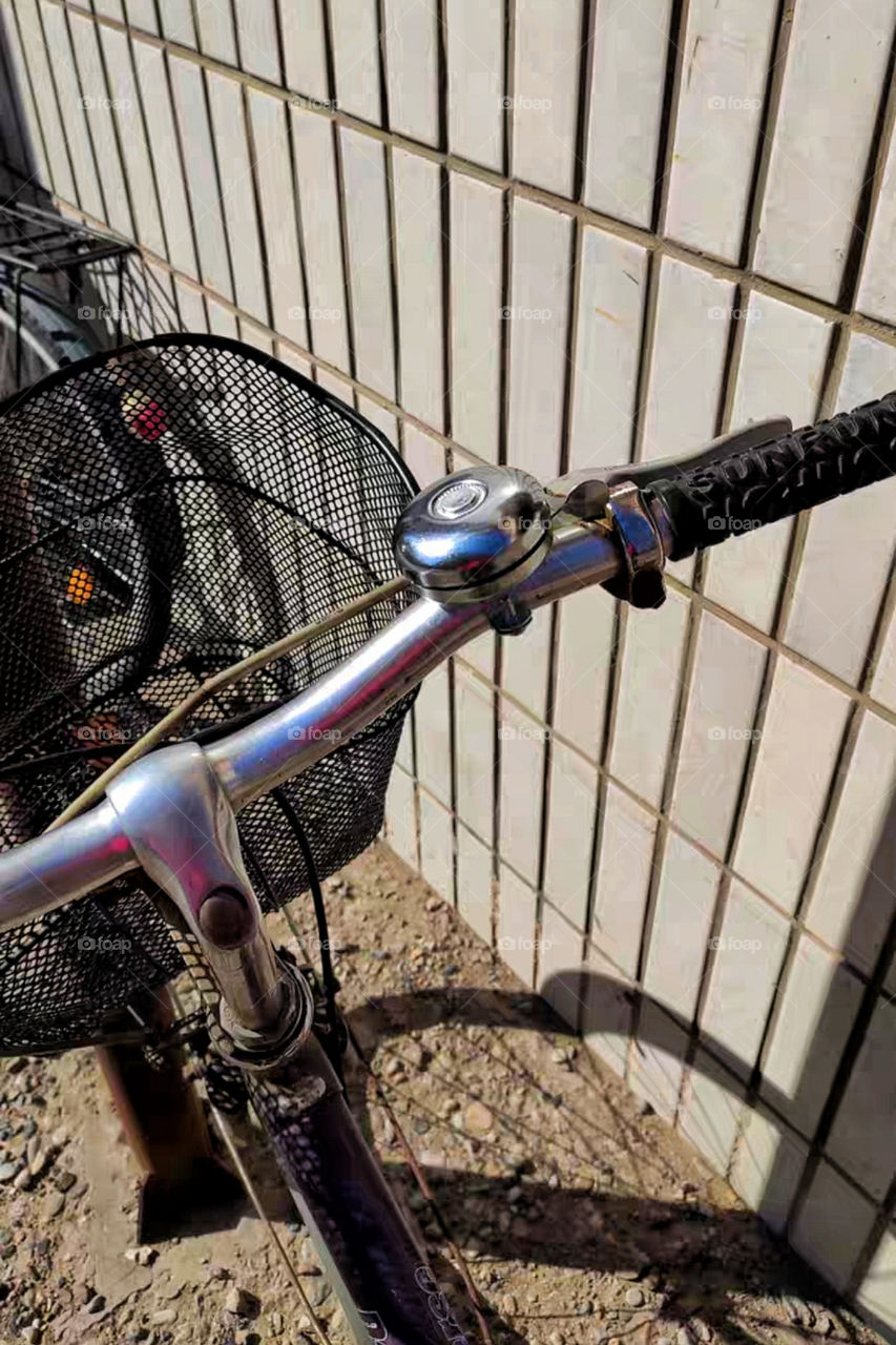 Bicycle Resting on the SideWalk Wearing Its Cute And Safe Silver Vintage Knog Bike Bell