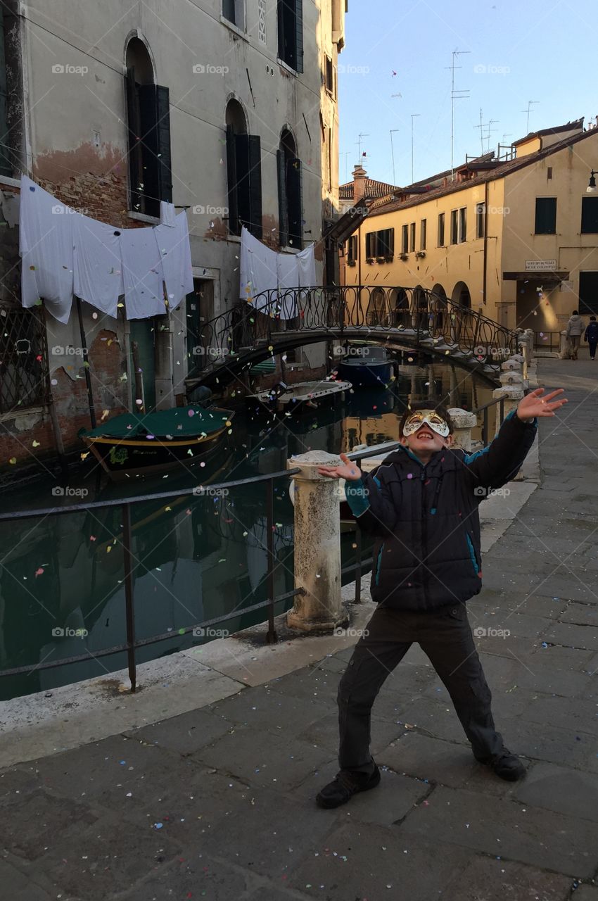 Throwing confetti in the air during Carnevale, Venice