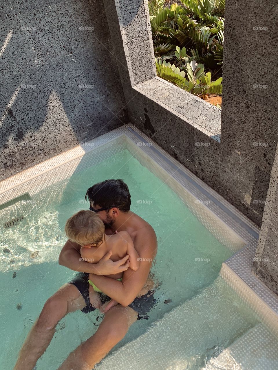 Father and son in pool 