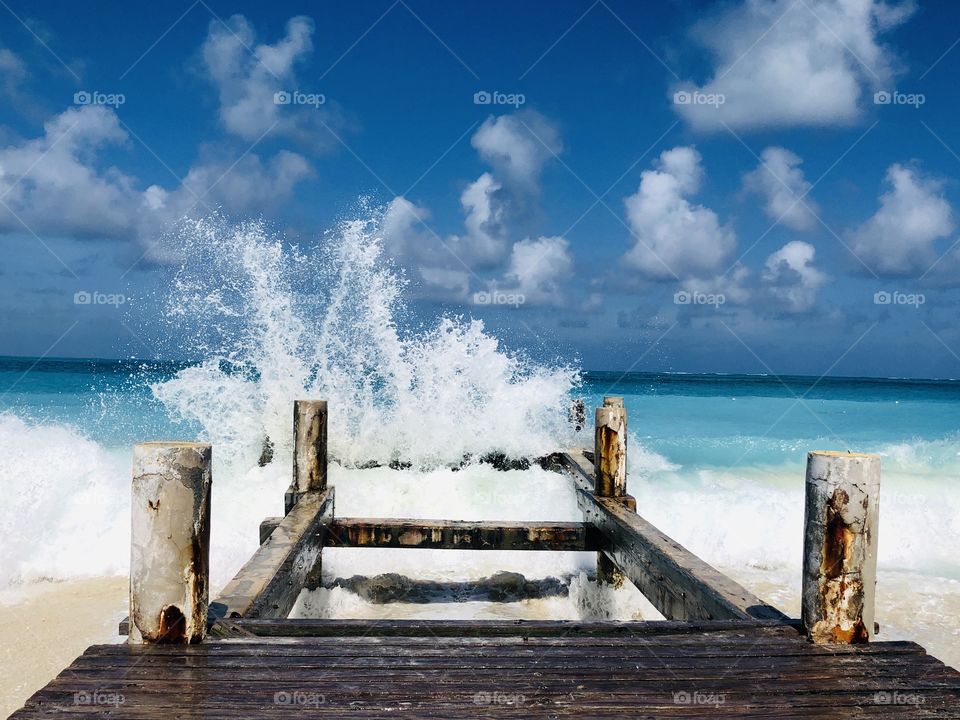 Waves slashing on wooden pier