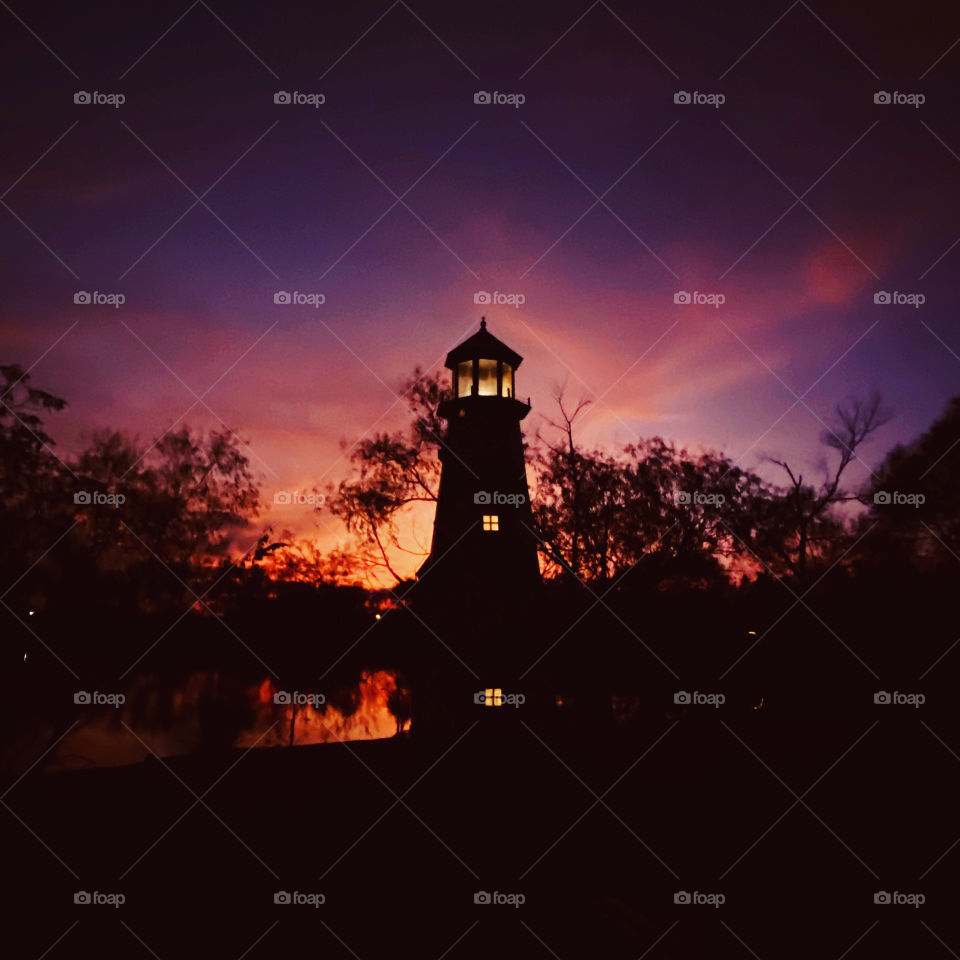 Silhouette and Shadows lighthouse standing firm. Ending Twilight readying this photo for Night. 