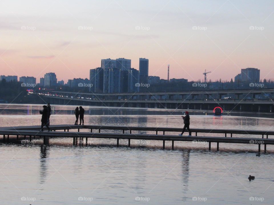 evening blue over the river in the city of Voronezh, Russia, the double-decker bridge is filled with cars