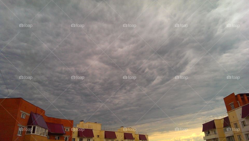 Low angle view building against cloudy sky