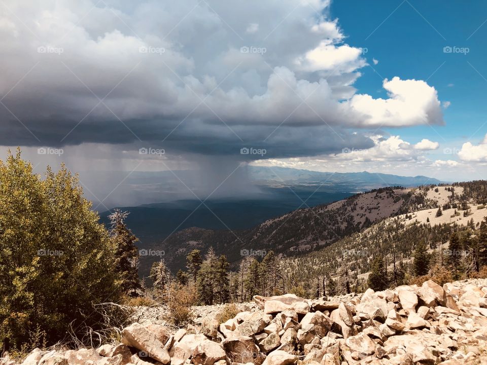 Rain over the Bonita River Valley and Capitan, NM with Sierra Blanca in the background taken from the Capitan Mountains