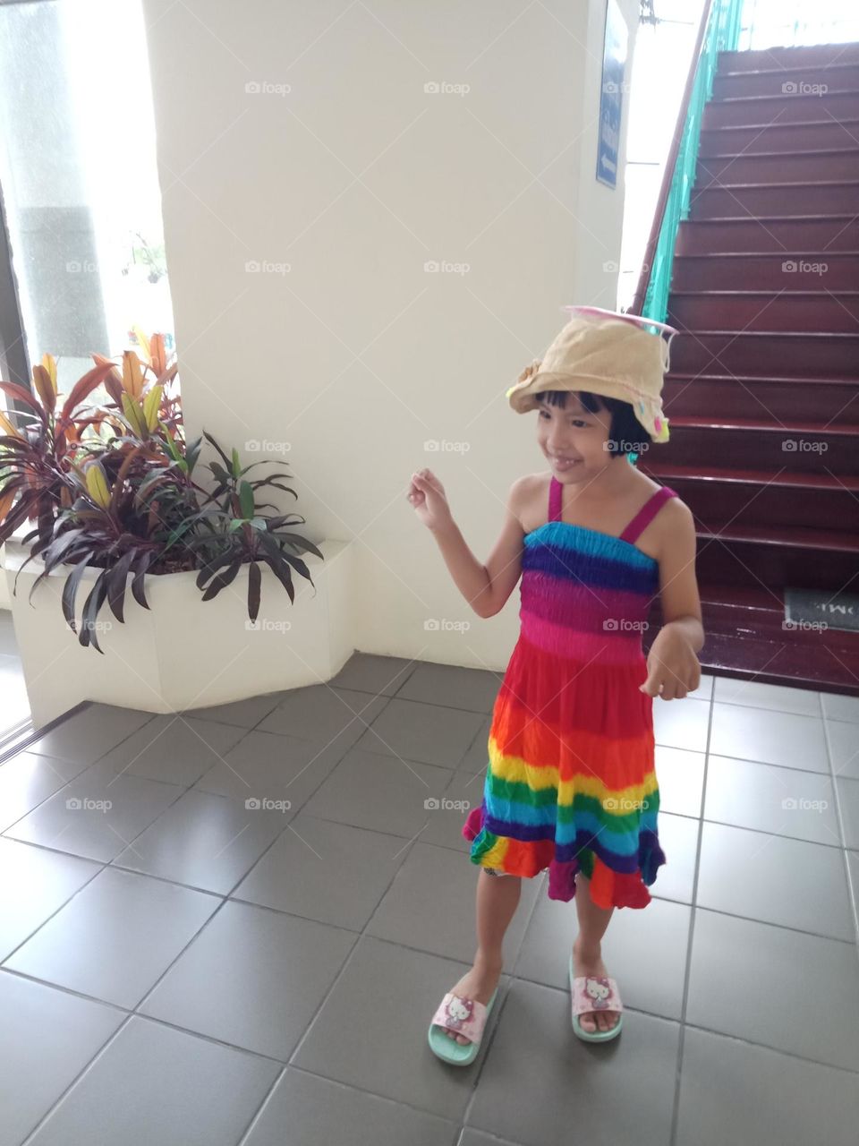 Smiling kid in rainbow dress