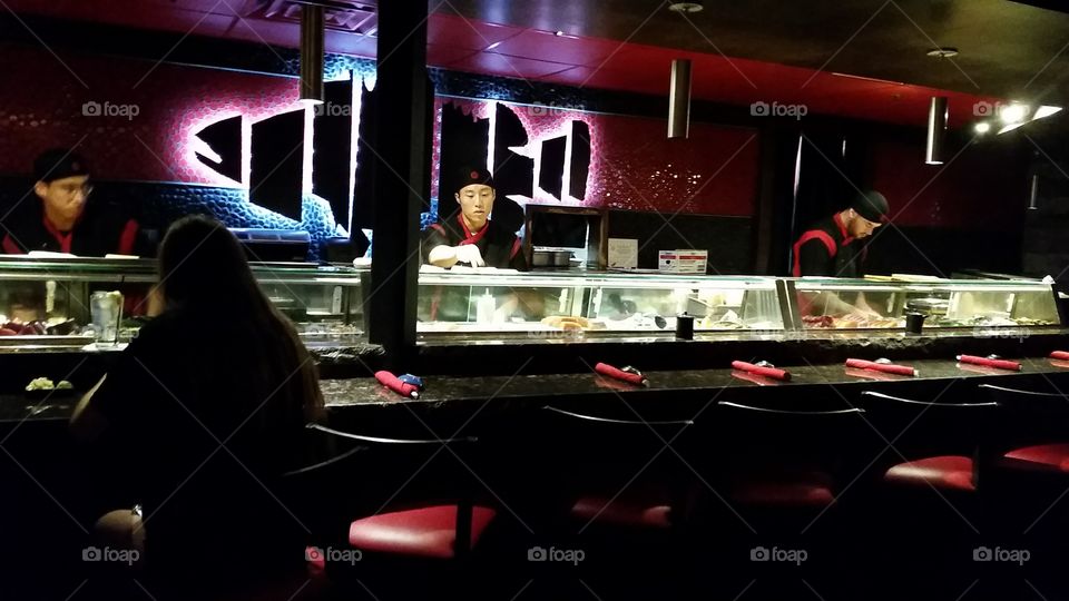 Sushi chefs and a bar