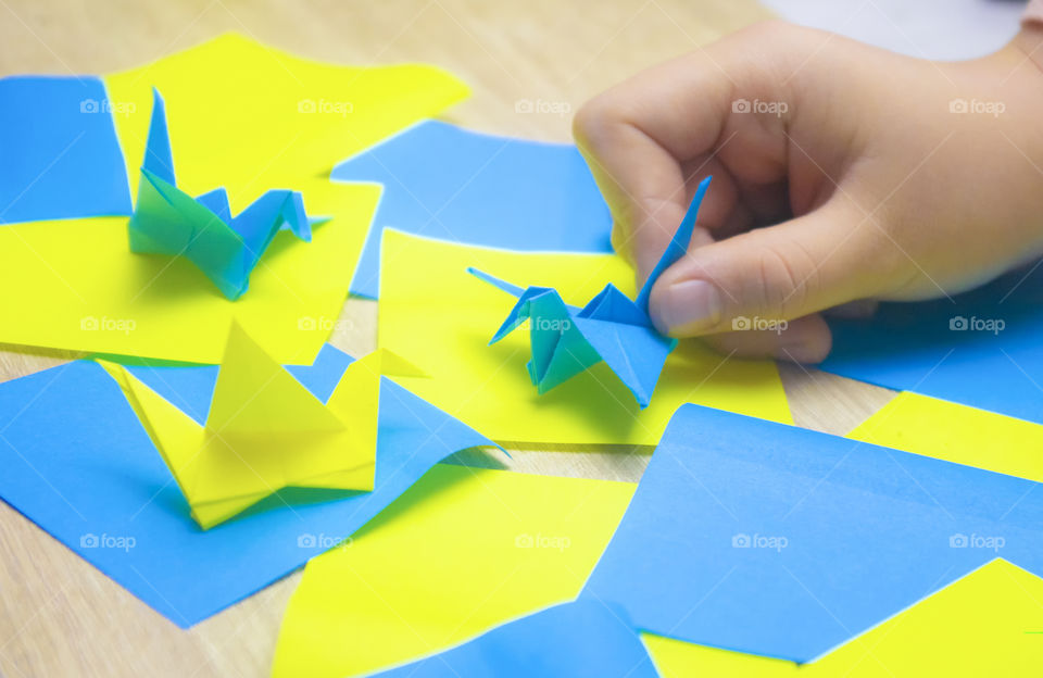 The child holds the origami cheering