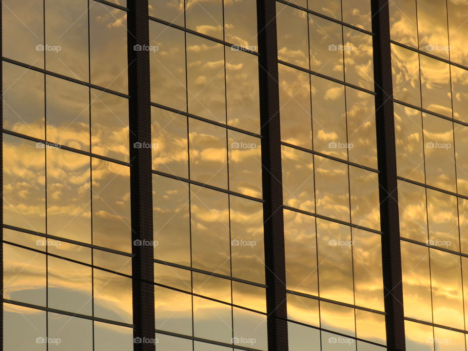 Everyone loves a reflection of a beautiful sunset with clouds on windows.
