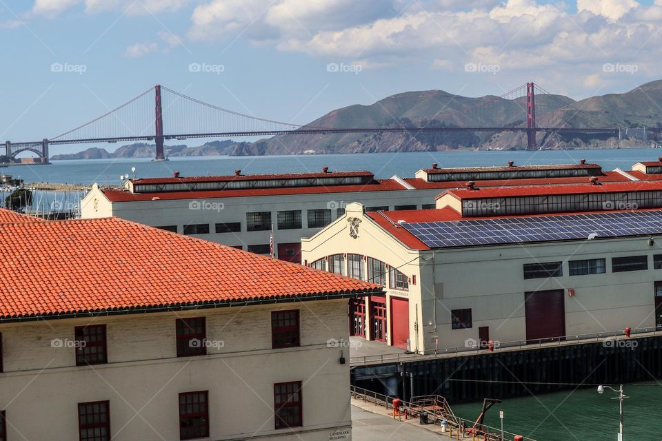 View of Fort Mason in San Francisco California on a warm afternoon with clouds in the sky and a beautiful view of the Golden Gate Bridge 