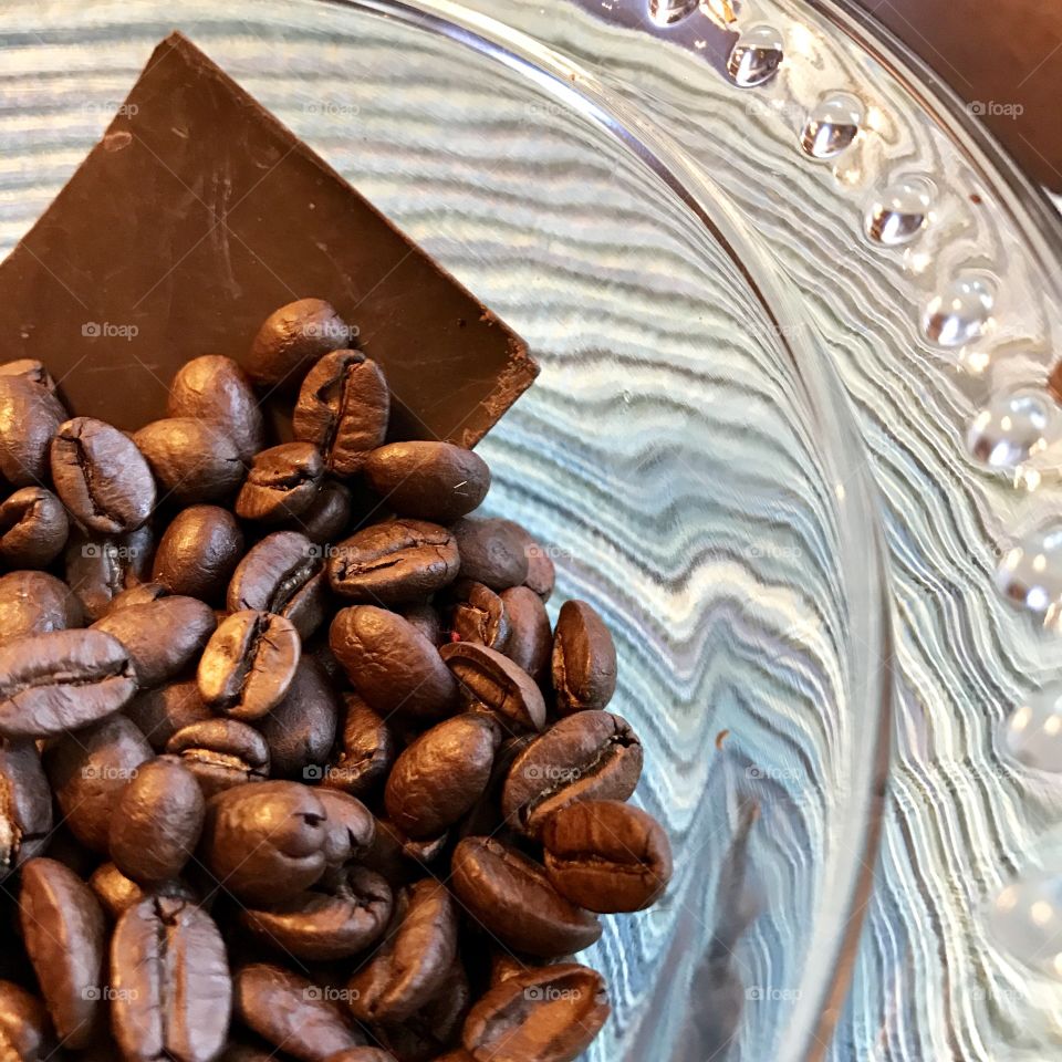 Roasted coffee beans with chocolate in glass bowl