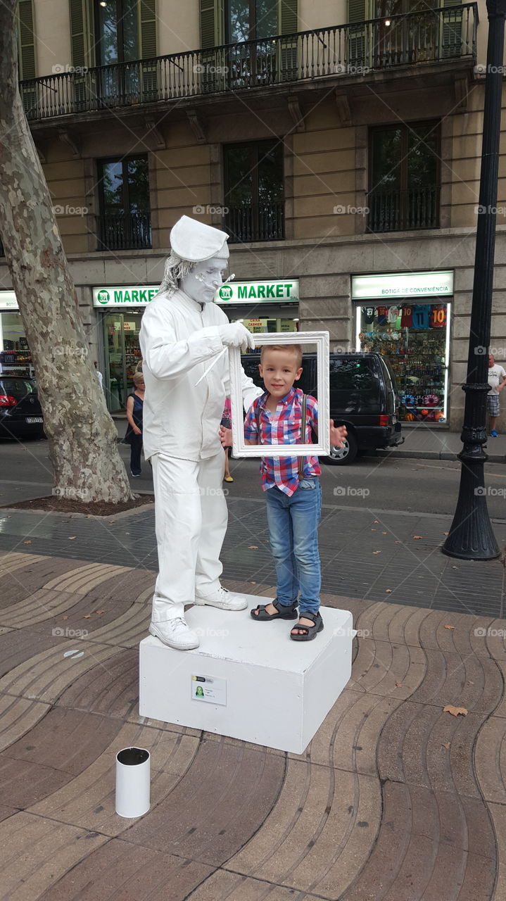 boy in Barcelona with a street actor