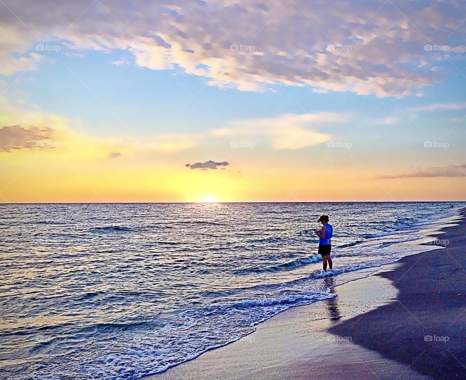 Woman enjoying a magnificent sunset.