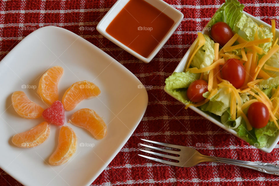 Crisp salad with a plate of mandarin oranges