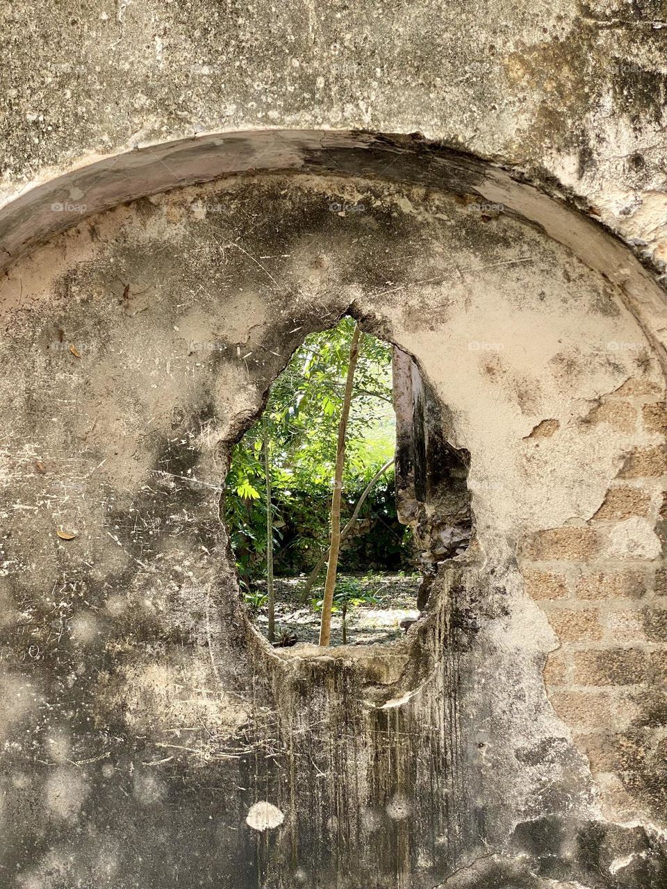 A hole in the wall of an old Spanish hacienda 