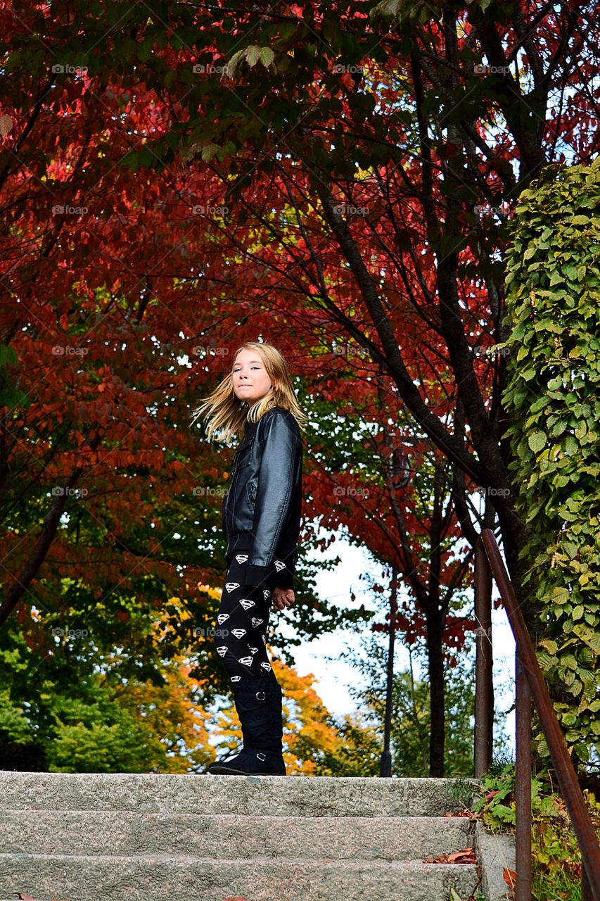 Girl standing on staircase during autumn
