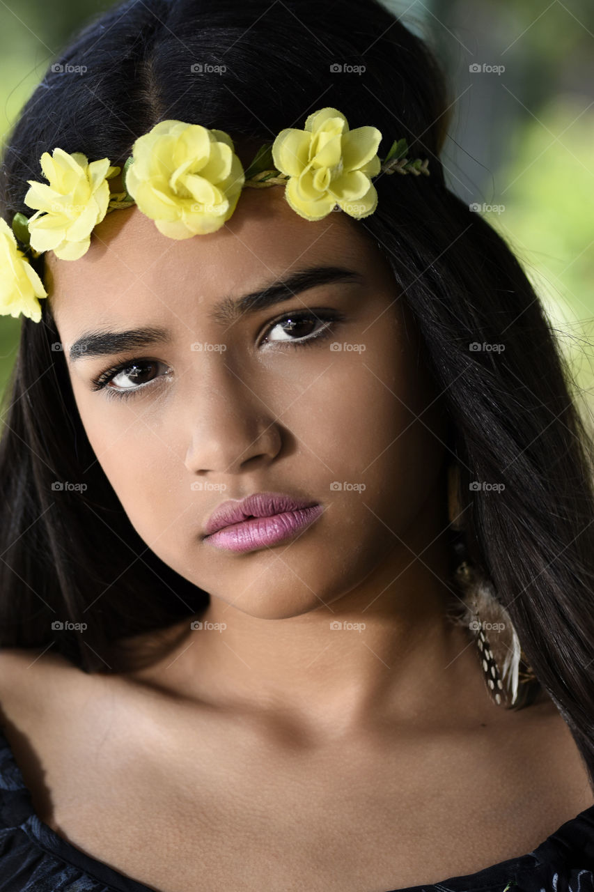 Portrait of Asian girl with yellow flower hair band
