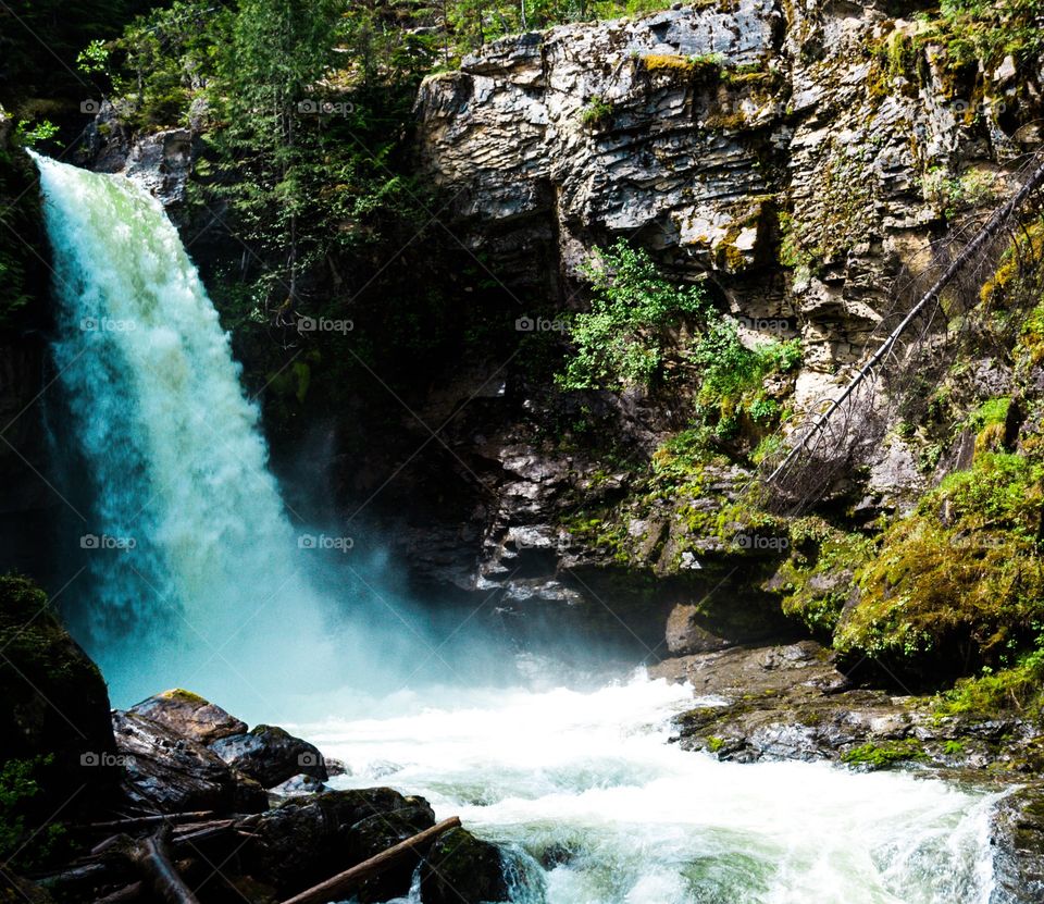 Turquoise alpine glacial waterfall 