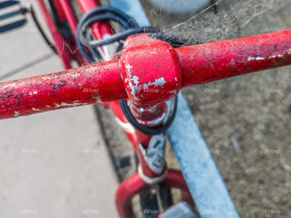  Abstract Vintage red bicycle along a fence highlighting the handlebars 