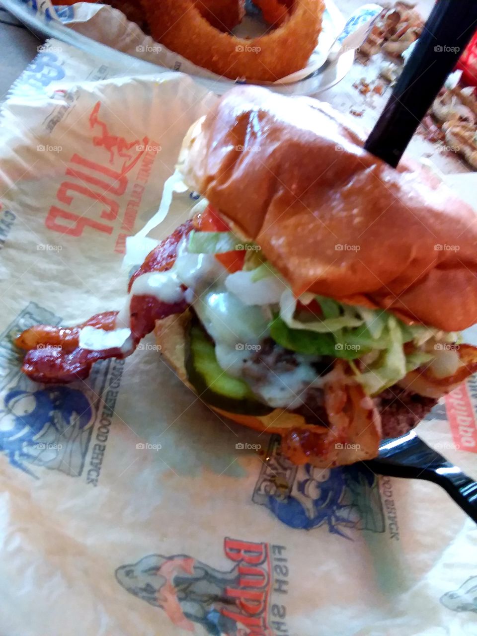 bacon cheeseburger with pepper Jack cheese pickles lettuce onions