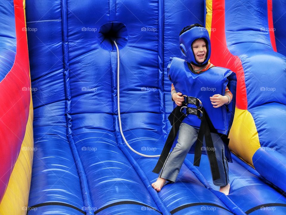 Happy Boy Playing On Bouncing Gear