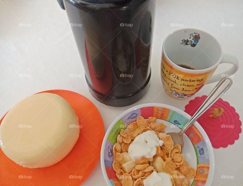 Breakfast table, circles everywhere, plate,bowl,cup, and cheese