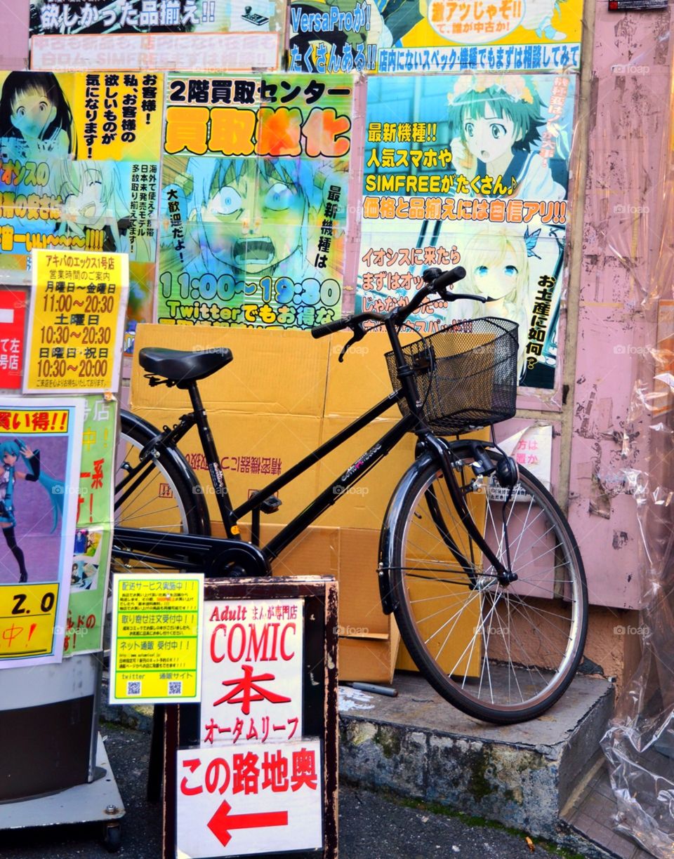 A bicycle parked in front of a manga and video shop in Tokyo, Japan 