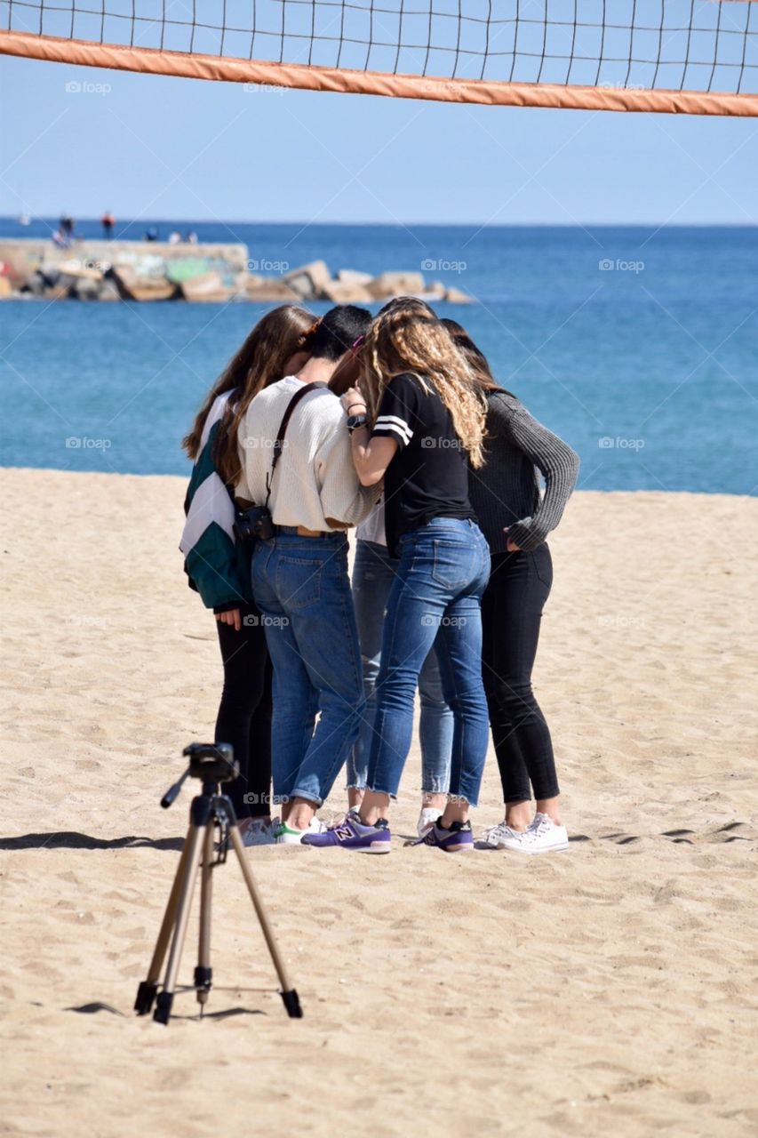 Group of girls looking at photos taken 