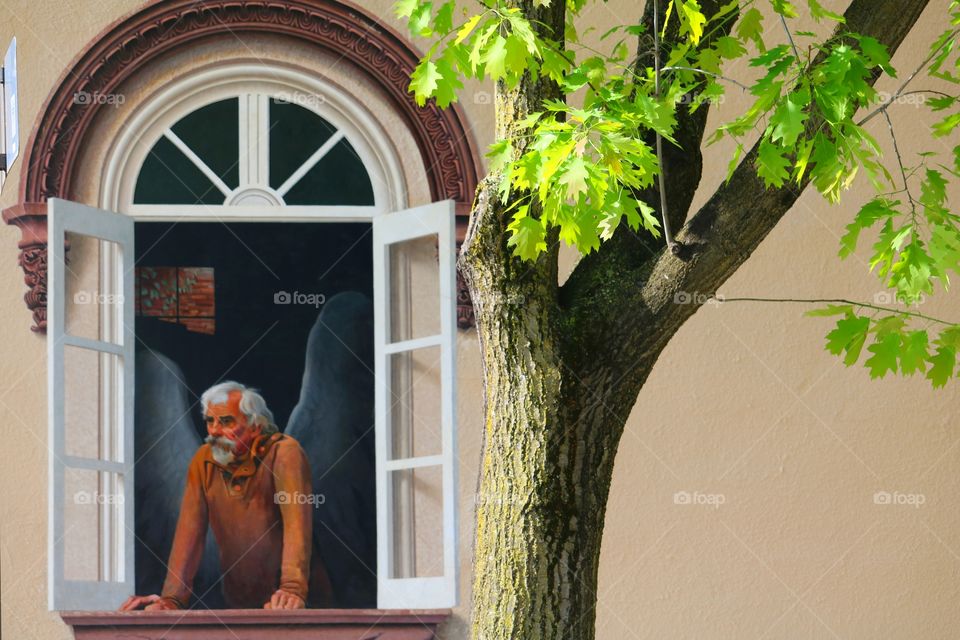 Senior man looking through window