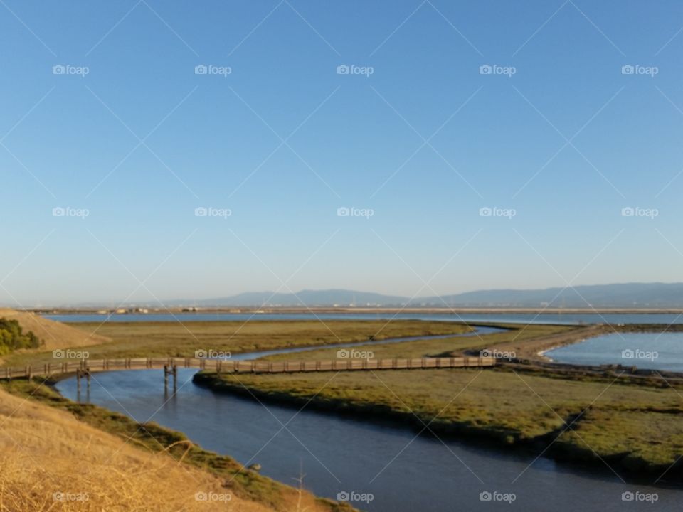 River or dlough and marsh. Meets the bay in a short distance