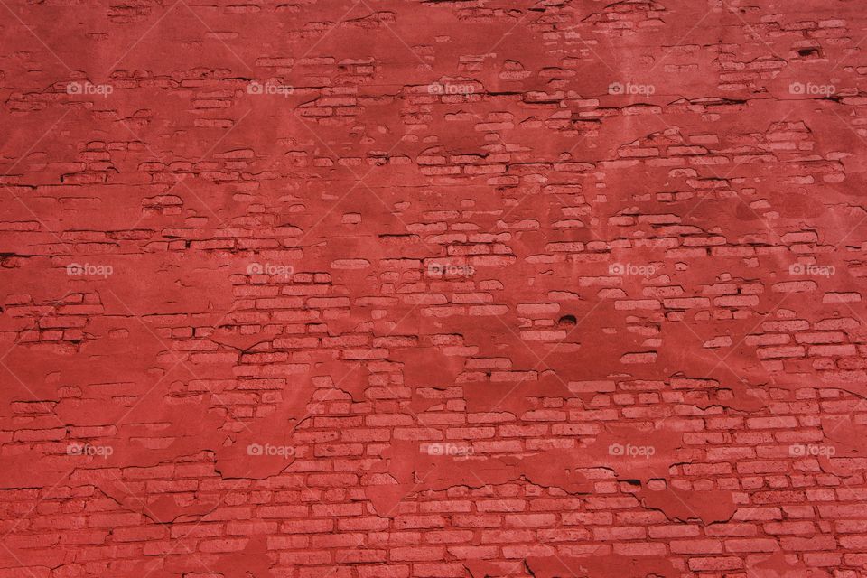 A closeup of a red painted brick wall of a commercial building in Brooklyn, New York City.