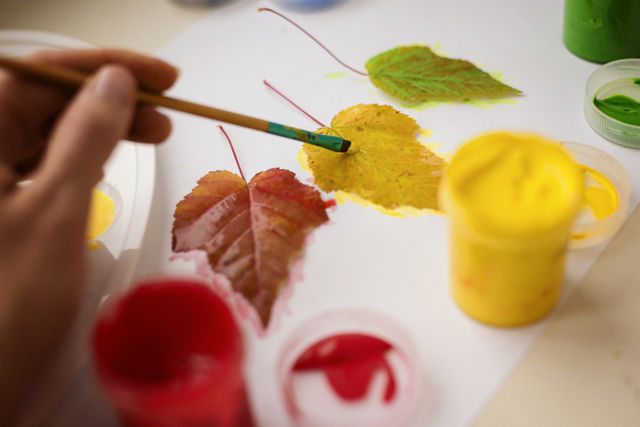 Close-up of a person painting leaf